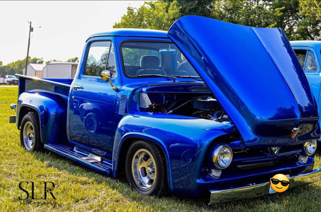 Blue classic pickup custom truck build with the hood open in the Antique Autoworks shop
